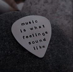 a guitar pick that says music is what feelings sound like