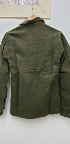 Vintage Military Issued Vietnam Era Wool ShirtSize-Extra SmallChest-up to 33 inches85% Wool 15% NylonDated-1976Condition-USED but looks NEW-see picsNSN# 8405-00-188-3794Made in the USA! check us out at www.armysurpluswarehouselexington.com Khaki Collared Winter Tops, Khaki Collared Tops For Winter, Vintage Khaki Tops For Winter, Fitted Military Style Top For Fall, Military Style Crew Neck Tops For Fall, Green Military Style Workwear Top, Military Style Long Sleeve Tops For Fall, Fitted Military Style Winter Tops, Military Style Button-up Tops For Fall