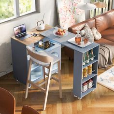 a living room filled with furniture and a laptop computer on top of a wooden table