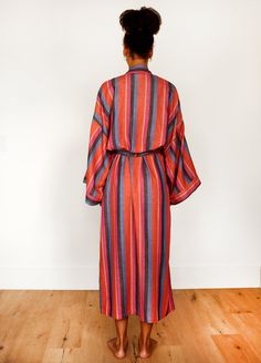 Take your tub time up a notch with our super soft, richly hued, 100% cotton long robe in Daze, a striking combo of pink, coral, blue, and black. Ethically handwoven on looms in India, the robe packs a punch with stripes that stand out. Complete your look with the matching hair wrap, scrunchie, and make-up bag. Trust us, you'll never want to get dressed again. Product Details: 100% cotton Unisex, one size: 51" length, 28" shoulder (across back), 28" waist (across back), 14" drop sleeve Fits up to Tub Time, Drop Sleeve, Chunky Scarves, Collar Cardigan, Hair Wraps, Pink Coral, Coral Blue, Sleepwear Robe, Make Up Bag