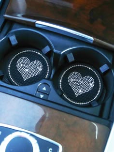 two speakers with hearts on them in a car