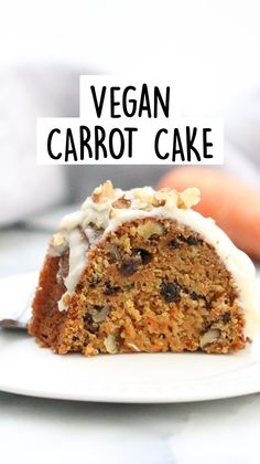 a close up of a piece of cake on a plate with the words vegan carrot cake above it