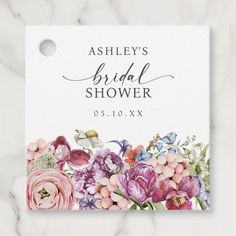 the floral bridal shower sign is shown on a marble surface