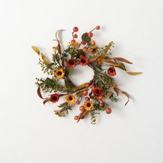 an arrangement of flowers arranged on a white surface