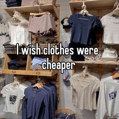 i wish clothes were cheaper on display in a store with shelves full of t - shirts