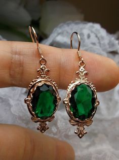 "Simulated Emerald Earrings Pin Design#E18 Custom Made These are Victorian reproduction estate earrings in rose gold plated sterling silver set with flawless A-quality simulated green emerald gemstones. Each stunning 6ct oval cut gem is 14mm long (9/16th\") and 10mm in width (3/8th\"). The earrings are 1 3/4th inches long. Notice the beautiful fleur de lis on the bottom and top of the setting. These lovely earrings were fashioned from an antique Victorian floral brooch. A gift box is included an Emerald Earrings, Victorian Jewelry, Lovely Earrings, Rose Earrings, Rose Gold Earrings, Silver Rose Gold, Dream Jewelry, Gold Plated Sterling Silver, Luxury Jewelry