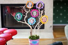 a family tree with pictures on it in a living room next to a fire place