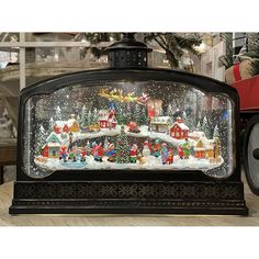 a snow globe with christmas scenes on it