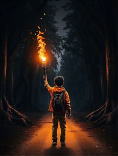 a man holding a lit candle in the middle of a forest at night with trees on both sides