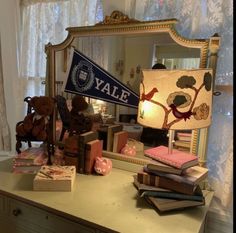 a desk with a lamp, mirror and stuffed animals on it