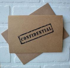 two brown envelopes with the word confident on them, sitting next to each other