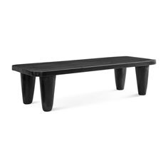 a black bench sitting on top of a white floor next to a wooden table with two legs