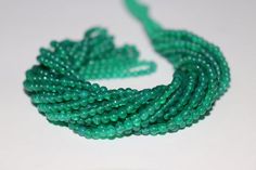 green seed beads on a white surface