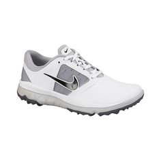 the nike golf shoe is white and grey with a metallic logo on the upper part