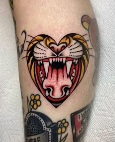 a close up of a tattoo with a tiger on it