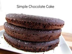 three chocolate cakes stacked on top of each other with the words, simple chocolate cake