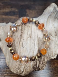 Let this Fall Bracelet dazzle your eyes with its glittering orange glass beads! . This is such a fun chunky bracelet and would be the perfect accessory to wear around the bonfire, cruising the pumpkin patch, or complimenting a new Fall outfit. Fall Handmade Jewelry, Autumn Bracelet Ideas, Fall Theme Bracelets, Fall Themed Beaded Bracelet, Fall Beaded Bracelets, Autumn Beaded Bracelet, Autumn Jewelry, Fall Bracelet Ideas, Halloween Glass Bead Bracelet