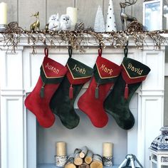 two stockings hanging from a mantel with candles and other christmas decorations on the mantle