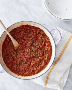 a large pot filled with chili on top of a table