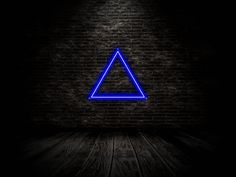 a blue neon triangle on a brick wall