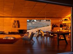 an open living room and dining area with sliding glass doors that lead to the outdoors