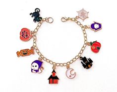 This happy and colorful Halloween charm bracelet is handcrafted by myself, and contains an assortment of enamel and acrylic charms.  The gold plated chain is 7 3/4 inches long with 10 drops containing  jack o lanterns, a ghost, a cat, moon and haunted house.  If you need it shorter or longer just let me know, and I will adjust it to as close as possible to the size you desire. If you would like a charm switched to something else just ask!  Each charm is placed with thought  for color and balance Halloween Gift Charm Bracelet, Handmade Halloween Charm Bracelet Gift, Handmade Charm Bracelet For Halloween Gift, Halloween Charm Bracelet, Colorful Halloween, Jack O Lanterns, Cat Moon, Halloween Charms, Acrylic Charms