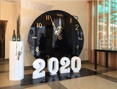 a large black clock sitting in the middle of a room