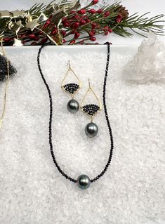 Tiny 1-2mm faceted Black Spinel sparkle along this pretty necklace, accented with a lovely Tahitian Pearl in the center. The Tahitian Pearl has beautiful luster with overtones of purple & green. A wonderful combination between the sparkles of the spinel and luster of the Tahitian Pearl. The necklace measures 16 with a 2" extender and is finished off with a lobster clasp and dangle of gold filled beads. Tahitian pearl measures 10mm. Each pearl is one of a kind with variations in color, shape & lu Elegant Beaded Black Spinel Jewelry, Fine Jewelry With Faceted Beads For Gifts, Elegant Rondelle Pearl Necklace With Faceted Beads, Elegant Pearl Necklace With Faceted Rondelle Beads, Elegant Faceted Rondelle Pearl Necklace, Elegant Single Strand Beaded Teardrop Necklace, Elegant Rondelle Jewelry With Faceted Beads, Elegant Jewelry With Faceted Rondelle Beads, Briolette Polished Beads Jewelry Gift