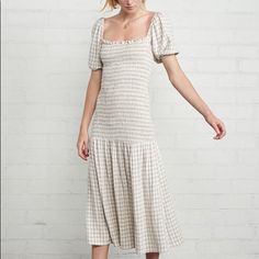 Cut From A Linen Blend, The Beige And Ivory Gingham Briar Dress Features A Smocked Bodice And Drop Waist That Connects To A Shirred Skirt. A Square Neckline And Short Puff Sleeves Add A Feminine Flair To This Mid-Length Silhouette. - 68% Rayon / 32% Linen-Woven Nwot - Only Tried On, Never Worn Outside Of The House Fitted Gingham Dress With Ruched Detail, Fitted Gingham Ruched Dress, Fitted Gingham Midi Dress With Ruffles, Spring Gingham Midi Dress With Square Neck, Gingham Dress With Ruffle Hem And Square Neck, Fitted Gingham Midi Dress With Square Neck, Fitted Gingham Midi Dress For Spring, Fitted Midi-length Plaid Dress For Picnic, Spring Gingham Smocked Dress With Short Sleeves