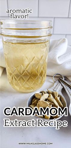 a jar filled with cardamom next to a spoon