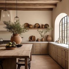 a kitchen filled with lots of counter top space next to a wooden dining room table