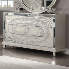 a mirrored cabinet with a circular mirror above it