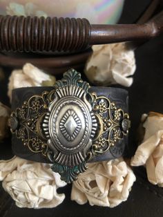 "Country leather bracelet cuff, western jewelry Distressed black embossed genuine leather 1 1/2\" strap has been adorned with an oval southwestern silver concho which sets on a detailed antiqued bronze filigree which has been given a rich patina attached to the leather with two textured gunmetal rivets. One gunmetal snap has been placed to fit up to a 7\" wrist. I can add another snap for a smaller or larger wrist size but you need to convo me before purchasing The last photos feature other item Adjustable Western Leather Bracelet For Festivals, Western Style Concho Bracelets For Festivals, Western Concho Bracelets For Festival, Rustic Hand Tooled Festival Bracelets, Western Style Adjustable Cuff Bracelet For Festivals, Adjustable Western Cuff Bracelet For Festivals, Adjustable Western Style Cuff Bracelet For Festivals, Adjustable Western Style Festival Cuff Bracelet, Vintage Adjustable Leather Bracelet With Concho