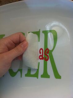 someone is cleaning the letters on a plate