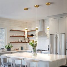 a kitchen with an island and several stools