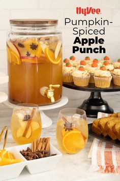 there are cupcakes, muffins and drinks on the table with pumpkin spiced apple punch