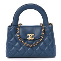 This is an authentic CHANEL Shiny Aged Calfskin Quilted Nano Kelly Shopper in Blue. This chic mini bag is crafted of quilted calfskin leather in blue. The bag features rolled top handles, an aged gold leather threaded shoulder strap, and a crossover strap with a gold CC turn lock. This opens to a blue leather interior with zipper and patch pockets. 1371725 Chanel Kelly Bag, Chanel Blue Bag, Coco Chanel Bag, Blue Chanel Bag, Coco Chanel Bags, Chanel Kelly, Women Bags Fashion Handbags, Navy Blue Bag, Chanel Blue