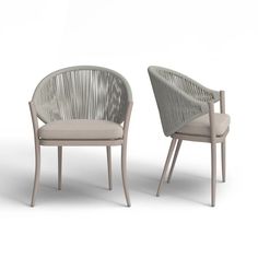 two chairs sitting next to each other on a white surface