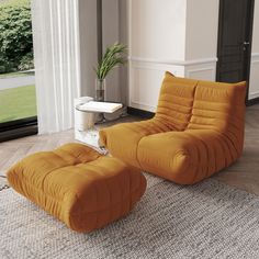 an orange chair and ottoman in a living room