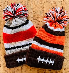 two knitted hats with footballs on them