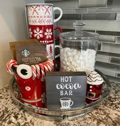 hot cocoa bar with mugs, marshmallows, and candy canes