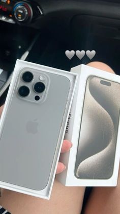 a person holding an iphone in their hand with the box open and it's inside