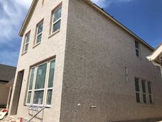 a house that is next to a building with a basketball hoop in front of it