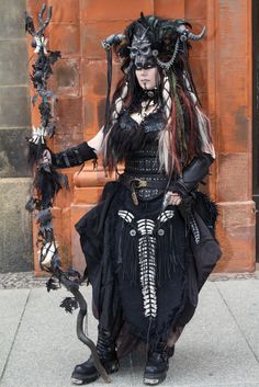 a woman dressed in black and white with horns