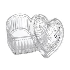 two clear glass heart shaped boxes on a white background, one is empty and the other has