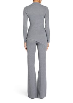 Long sleeve, high neck knit top with asymmetric hem. Pair with our Mickie Knit Flare Pant for a matching set look. Shown here in Heathered Grey. 65% Viscose, 35% Nylon Made in China Model is 5'10" wearing size S Style No. 4323-12 Fall Wardrobe Staples, Fall Forward, Romper And Jacket, Knit Outerwear, Flare Pant, Knit Shoes, Knit Denim, Closet Essentials, Fall Shoes