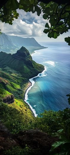 an ocean view from the top of a hill with lush green hills and blue water