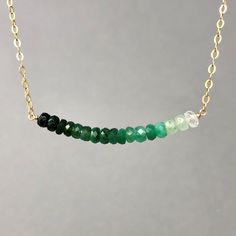 Beautiful, vibrant green emerald stones line up in a row and hang on a 16 inch gold fill, rose gold fill, or sterling silver chain. Beads line up to measure approx 1.5 inches in width. These are real raw emerald stones. 18 inch or 20 inch chain is also available at no additional charge. I have a smaller version of this necklace here: https://www.etsy.com/listing/157588589/small-real-green-emerald-stone-beaded Great piece to layer! Item comes packaged in a little brown box. Real Green, Green Stone Necklace, Raw Emerald, Silver Bead Necklace, Stone Beaded Necklace, Gold Bead Necklace, Buy Necklace, Emerald Stone, Delicate Jewelry