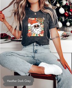 OxbridgeCo Retro Santa Shirt, Santa Claus Shirt, Vintage Santa Shirt, Christmas Shirt, Christmas Party Tee, Christmas Santa Shirt,Funny Christmas Shirt This customized gift can be used by all the members of family, it will be the best wanderlust, travel apparel unisex personalized shirt ever! 👉 Product Details:The T-Shirts, Hoodies, Youth, Toddler and Baby Suits(onesie) are unisex.👈 👉Reading the Sizing Chart: Please note that the sizing chart includes the measurements of one side of the shirt, not the circumference. 👈 👉Please review all the sizing charts that were added in the product pictures. 👉How Do I Order👈 1️⃣ Please review all the information provided before placing an order 2️⃣ Select the shirt type and size using the drop down menu. 3️⃣ Select the color of the shirt using th Fun Christmas T-shirt For Holiday, Casual Christmas Tops With Funny Print, Fun Christmas Graphic Print Tops, Casual Holiday Shirt With Graphic Print, Casual Tops With Funny Print For Holidays, Casual Graphic Print Shirt For Holiday, Fun Short Sleeve Winter Tops, Fun Crew Neck Tops For Holiday, Funny Christmas Holiday Tops