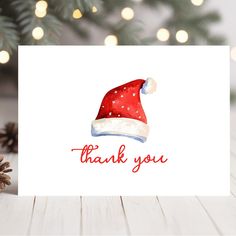 a christmas card with a santa hat on it and the words thank you written in red